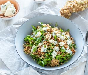 Couscous-Salat mit getrockneten Tomaten im tiefen Teller.
