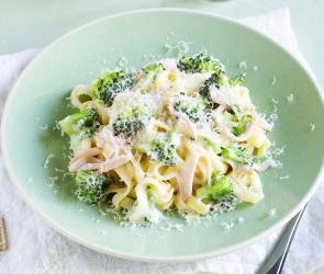 Pastagericht mit Brokkoli und Schinken auf einem Teller.