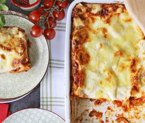 Lasagne in einer Auflaufform und auf einem Teller.