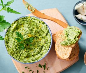 Zitronenbutter mit Kräutern in einer Schüssel.