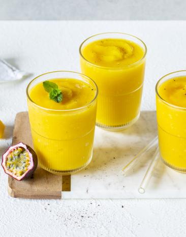 Mango-Maracuja-Slush serviert in drei Gläsern.