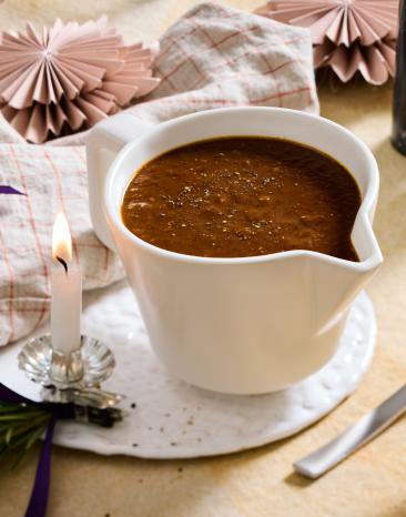 Vegetarische Bratensauce mit Pflaumen in einer Sauciere..