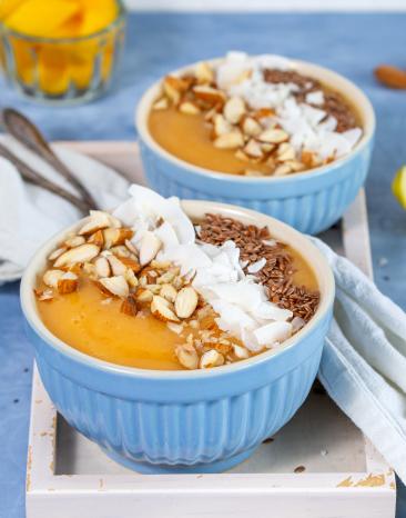 Smoothie Bowl in Schüsseln mit Kokosflocken und Nüssen garniert